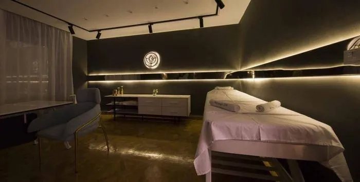 Private treatment room with the backlit Hollywood Clinic lotus emblem