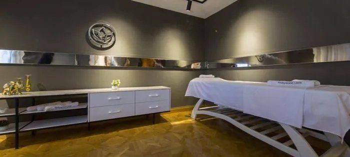 Treatment room with massage bed and branded towels
