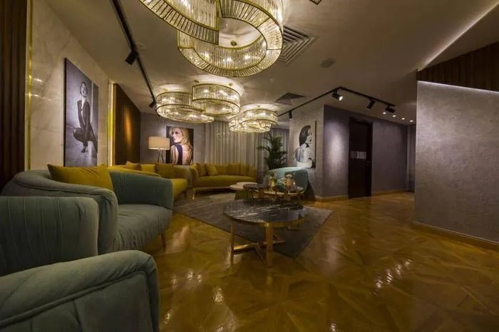 Lounge beneath cascading crystal chandeliers